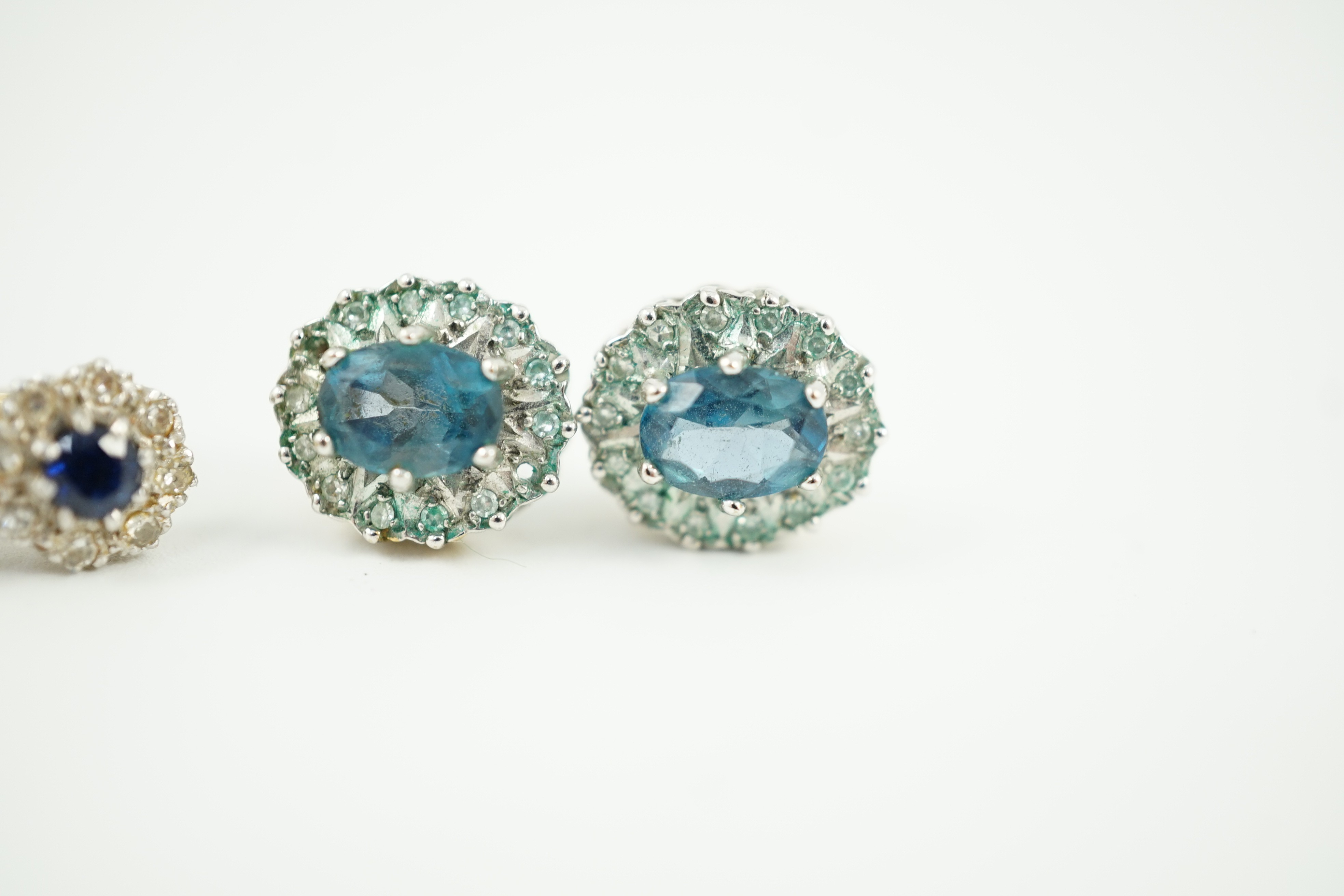 A modern pair of 18ct gold, sapphire and diamond cluster set ear studs, 8mm, gross weight 2.7 grams and a pair of 9ct ear studs, gross 3 grams.